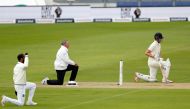 England's Dom Sibley (R) 'takes a knee' in support of the Black Lives Matter movement ahead of on the first day of the first Test cricket match between England and the West Indies at the Ageas Bowl in Southampton, southwest England on July 8, 2020. / AFP 