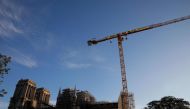 Greenpeace activists hang, on a crane, a giant banner reading 