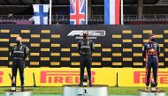 Mercedes' British driver Lewis Hamilton (C), second placed Mercedes' Finnish driver Valtteri Bottas (L) and third placed Red Bull's Dutch driver Max Verstappen celebrate on the podium after the Formula One Styrian Grand Prix race on July 12, 2020 in Spiel