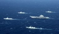 (FILES) This aerial file photo taken on January 2, 2017 shows a Chinese Navy formation, including the aircraft carrier Liaoning (C), during military drills in the South China Sea.  China OUT / AFP / STR