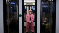A train worker wearing personal protective equipment for protection against the coronavirus disease (COVID-19) stands inside an almost empty train, in Quezon City, Metro Manila, Philippines, July 14, 2020. REUTERS/Eloisa Lopez