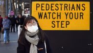 A pedestrian walks past a sign in Melbourne's central business district on July 16, 2020, as Australia announced 1.4 billion USD to retrain workers impacted by the coronavirus fallout, with unemployment rising to its highest level in more than two decades