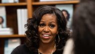 In this file photo taken on November 18, 2019, former US First Lady Michelle Obama meets with fans during a book signing on the first anniversary of the launch of her memoir 