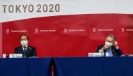 President of the Tokyo 2020 Organising Committee Yoshiro Mori (R), and Tokyo 2020 Organising Committee CEO Toshiro Muto, wearing face masks attend a news conference after giving a presentation to the International Olympic Committee (IOC) about the rearran