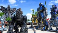 This photograph taken on July 18, 2020 shows a child looking at a figure of King Kong in front of life-sized sculptures of characters from the 