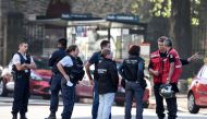 Firefighters and scientific police officers speak in front of the Saint-Pierre-et-Saint-Paul cathedral in Nantes, western France, on July 19, 2020. French investigators were on SJuly 19 questioning a man who worked at the cathedral in the city of Nantes w