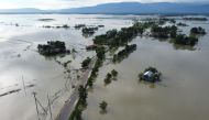TOPSHOT - In this aerial photo inundated houses are seen in Sunamgong on July 14, 2020. Almost four million people have been hit by monsoon floods in South Asia, officials said July 14, with a third of Bangladesh already underwater from some of the heavie