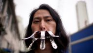 Brother Nut, Chinese performance artist with three metallic clips sealing his mouth, poses for a picture in Shanghai, following the coronavirus disease (COVID-19) outbreak, China July 13, 2020. Picture taken July 13, 2020. REUTERS/Aly Song