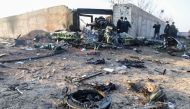  A file photo taken on January 08, 2020 shows people and rescue teams are pictured amid the wreckage after a Ukrainian plane carrying 176 passengers crashed near Imam Khomeini airport in the Iranian capital Tehran early in the morning. AFP / ISNA / ISNA /