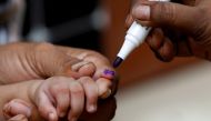 A boy gets his finger marked, after he is administered polio vaccine drops, during an anti-polio campaign, in a low-income neighbourhood as the spread of the coronavirus disease (COVID-19) continues, in Karachi, Pakistan July 20, 2020. REUTERS/Akhtar Soom