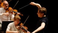 In this file photo taken on July 7, 2020, Finnish conductor Klaus Makela conducts the Paris' Orchestra during a rehearsal at The Philharmonie de Paris concert hall in Paris. He is the new wunderkind of classical music. At only 24, the young Finn Klaus Mak