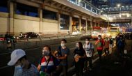 Passengers wearing face masks for protection against the coronavirus disease (COVID-19) queue to ride a bus in Quezon City, Metro Manila, Philippines, July 21, 2020. REUTERS/Eloisa Lopez