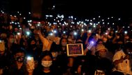 Demonstrators light up their smartphones as they gather during a protest demanding the resignation of Thailand's Prime Minister Prayut Chan-o-cha, under a highway in Pathum Thani, at the outskirts of Bangkok, Thailand, July 23, 2020. REUTERS/Jorge Silva
