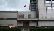 The Chinese flag flies outside of the Chinese consulate in Houston after the US State Department ordered China to close the consulate in Houston, Texas, July 22, 2020. / AFP / AFP / Mark Felix
