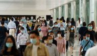 People wearing face masks following the coronavirus disease (COVID-19) outbreak walk at a shopping mall in Hong Kong, China July 20, 2020. REUTERS/Lam Yik
