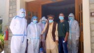 Abdul Alim, 103, stands with his son Suhail Aziz and staff members wearing personal protective equipment (PPE) in this group photograph taken after he recovered from coronavirus disease (COVID-19) and was discharged from the Aga Khan Health Services Emerg