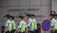Policemen walk past the US consulate in Chengdu, in Sichuan province on July 25, 2020.  AFP / Noel Celis