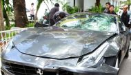 (FILES) In this file photo taken on September 3, 2012, police officers look at a Ferrari that was allegedly involved in a hit-and-run accident during their investigation at Thong Lor police station in Bangkok. / AFP /STR
