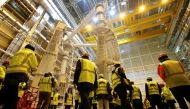 FILE PHOTO: Technicians and visitors stand inside the International Thermonuclear Experimental Reactor (ITER) assembly hall in Saint-Paul-lez-Durance, southern France, November 7, 2019. REUTERS/Jean-Paul Pelissier/File Photo