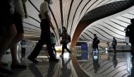 FILE PHOTO: People wearing face masks following the coronavirus disease (COVID-19) outbreak are seen at Beijing Daxing International Airport in Beijing, China July 23, 2020. REUTERS/Thomas Suen/File Photo