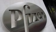 In this file photo the Pfizer company logo is seen in front of Pfizer’s headquarters April 27, 2016 in New York. Pfizer reported a drop in second-quarter profits on July 28, 2020, but lifted its full-year forecast on expectations that medical activities c