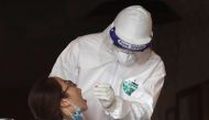 A health worker of Hanoi CDC gets test samples from an employee of a pizza restaurant where another employee tested positive with the coronavirus disease (COVID-19) after travel from Da Nang city, in Hanoi, Vietnam July 29, 2020. REUTERS/Kham