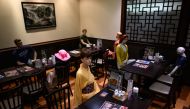 Mannequins, used as a method to maintain social distancing among diners, are seen seated in a restaurant in the Akabane district of Tokyo on July 26, 2020, amid the COVID-19 coronavirus pandemic. / AFP / Philip Fong