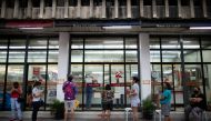 Filipinos queue outside a pharmacy, a day before the Philippine capital goes back to a stricter lockdown amid coronavirus disease (COVID-19) infections spike, at a public market in Manila, Philippines, August 3, 2020. REUTERS/Eloisa Lopez