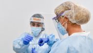 Healthcare workers collect samples at a testing room for the novel coronavirus COVID-19 at a primary health care center in Barcelona on August 3, 2020.  / AFP / Pau BARRENA