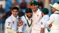 This file photo taken on February 7, 2020 shows Pakistan's Azhar Ali (2nd L) celebrating with teammates Naseem Shah (L) and Shaheen Shah Afridi (3rd L) after the dismissal of Bangladesh's Mohammad Mithun (unseen) during the first day of the first cricket 
