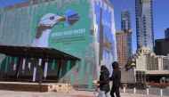 A sign in Federation Square urges people to wear a mask in the central business district in Melbourne on August 6, 2020. Australia's second city Melbourne entered a more restrictive six-week lockdown on August 6, sparking a fresh wave of anxiety and confu