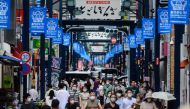 TOPSHOT - People wearing face masks as a preventive measure against the COVID-19 coronavirus visit Togoshi Ginza shopping street in Tokyo on August 1, 2020. / AFP / Philip FONG
