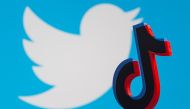 A 3D-printed Tik Tok logo is placed in front of a displayed Twitter logo in this illustration picture taken August 9, 2020. REUTERS/Dado Ruvic/Illustration
