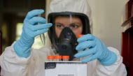 A scientist works inside a laboratory of the Gamaleya Research Institute of Epidemiology and Microbiology during the production and laboratory testing of a vaccine against the coronavirus disease (COVID-19), in Moscow, Russia August 6, 2020. Picture taken