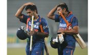(FILES) In this file photo taken on January 8, 2010, Indian cricket team captain Mahendra Singh Dhoni (L) and teammate Suresh Raina walk off the pitch after victory in the Tri-Nation tournament cricket match between Bangladesh and India at The Sher-e Bang