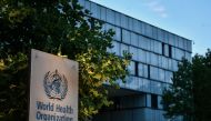 A photo taken in the late hours of August 17, 2020 shows a sign of the World Health Organization (WHO) at their headquarters in Geneva amid the COVID-19 outbreak, caused by the novel coronavirus. / AFP / Fabrice COFFRINI