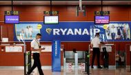 A man stands at a Ryanair check-in desk at Josep Tarradellas Barcelona-El Prat airport, amid the spread of the coronavirus disease (COVID-19), in Barcelona, Spain, July 26, 2020. REUTERS/Albert Gea/File Photo