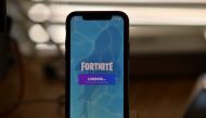 This file illustration photo taken on August 14, 2020 shows Epic Games' Fortnite loading on a smartphone in Los Angeles on August 14, 2020.  / AFP / Chris DELMAS