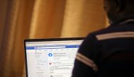 FILE PHOTO: FILE PHOTO: A man opens the Facebook page on his computer to fact check coronavirus disease (COVID-19) information, in Abuja, Nigeria March 19, 2020. REUTERS/Afolabi Sotunde -/File Photo
