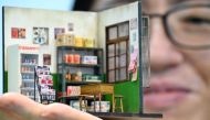 In this picture taken on August 5, 2020, miniature model artist Chen Shih-jen poses for a photograph with his work during an interview at FM Dioramas in Taoyuan, northern Taiwan. AFP / Sam Yeh 