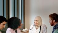 A female doctor leading a multi-ethnic medical team.