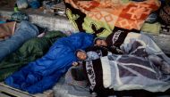 Refugees and migrants from the destroyed Moria camp sleep on the side of a road, on the island of Lesbos, Greece, September 13, 2020. REUTERS/Alkis Konstantinidis