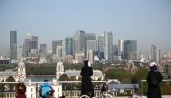 A skyline of the Canary Wharf financial district is seen as people enjoy the weather in London, Britain September 14, 2020. REUTERS/Hannah McKay
