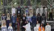 Designer Riccardo Tisci poses backstage with models wearing creations from the Burberry Spring/Summer 2021 Collection during the London Fashion Week, amid the coronavirus disease (COVID-19) outbreak, in an undisclosed location, Britain, September 17, 2020