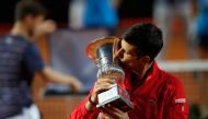 Serbia's Novak Djokovic kisses his trophy after winning the final match of the Men's Italian Open against Argentina's Diego Schwartzman at Foro Italico on September 21, 2020 in Rome, Italy. / AFP / POOL / Clive Brunskill
