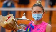 Romania's Simona Halep holds her trophy after winning the final match of the Women's Italian Open against Czech Republic's Karolina Pliskova, who pulled out following injury, at Foro Italico on September 21, 2020 in Rome, Italy. / AFP / POOL / Riccardo An