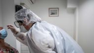 A medical assistant takes a sample from a patient for a coronavirus (Covid-19) test at an analysis laboratory in Le Peage-de-Roussillon, some 30kms south of Lyon, south-eastern France on September 22, 2020. / AFP / JEFF PACHOUD