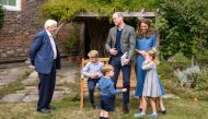 A handout photo released by Britain's Prince William and Cathrine, Duchess of Cambridge, Prince George (seated), Princess Charlotte and Prince Louis with David Attenborough after Prince William and David Attenborough attended an outdoor screening of the u