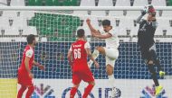 Persepolis’ goalkeeper Hamed Lak (right) grabs the ball ahead of Sadd’s forward Baghdad Bounedjah during the AFC Champions League Round of 16 match, played at the Education Stadium yesterday