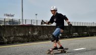 Longboarder and cancer survivor Nongluck Chairuettichai, also known as Jeab, during a practice session on an unfinished highway ramp in Bangkok. AFP / Lillian SUWANRUMPHA